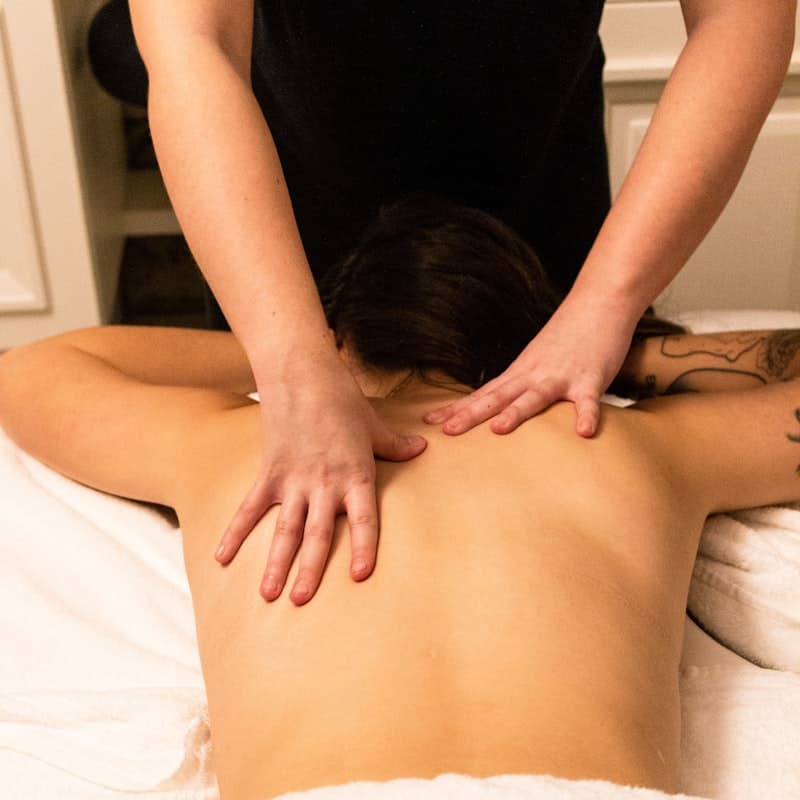 Guest receiving a full-back massage at the spa
