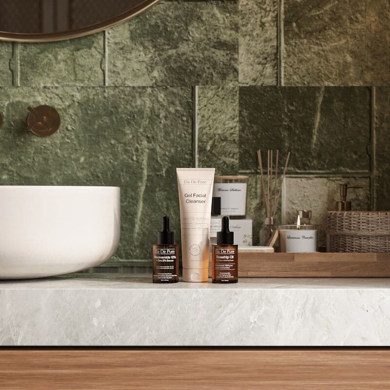 Premium skincare and massage oils on a green marble counter